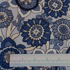 Blue floral fabric pattern with measuring ruler.