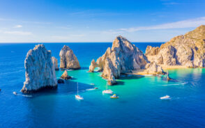 The rocks on the ocean pictured during the best time to visit Cabo San Lucas