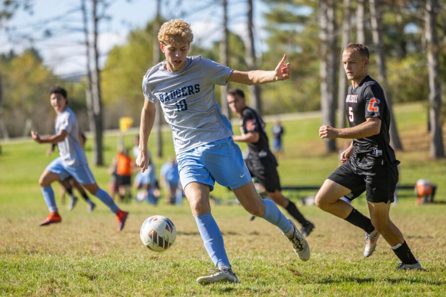 A young man kicking a soccer ball during a game