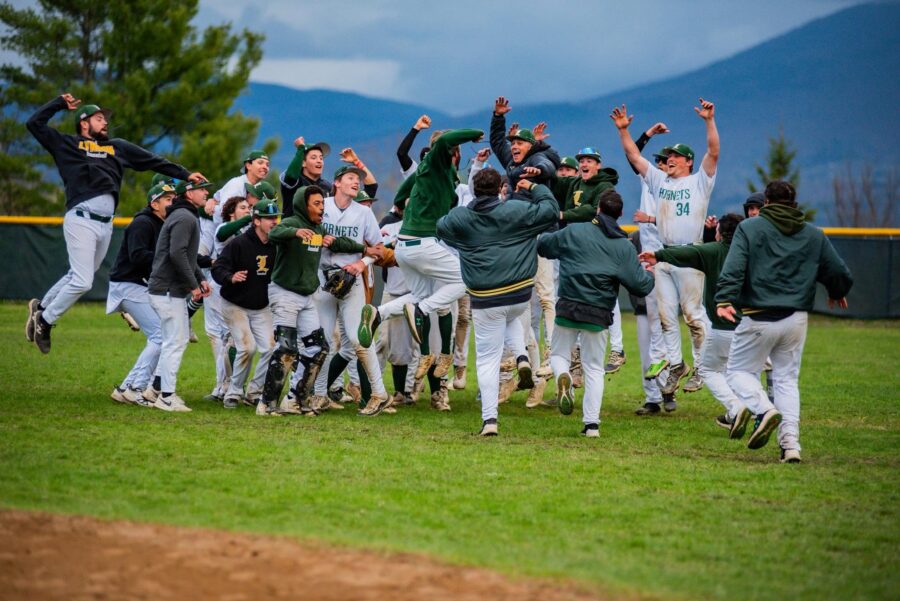 A group of VTSU Lyndon baseball players cheering and celebrating on the field