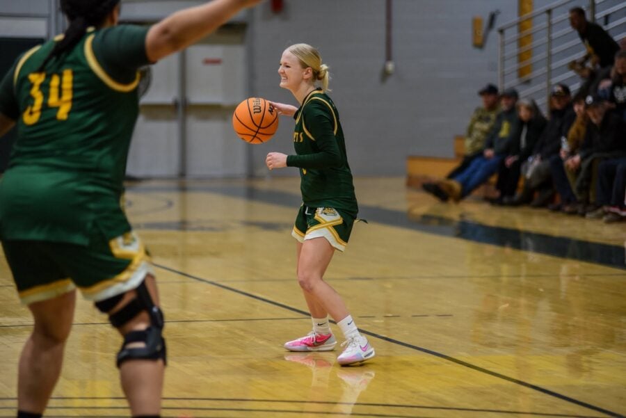 A women's basketball player on the court in the middle of a game