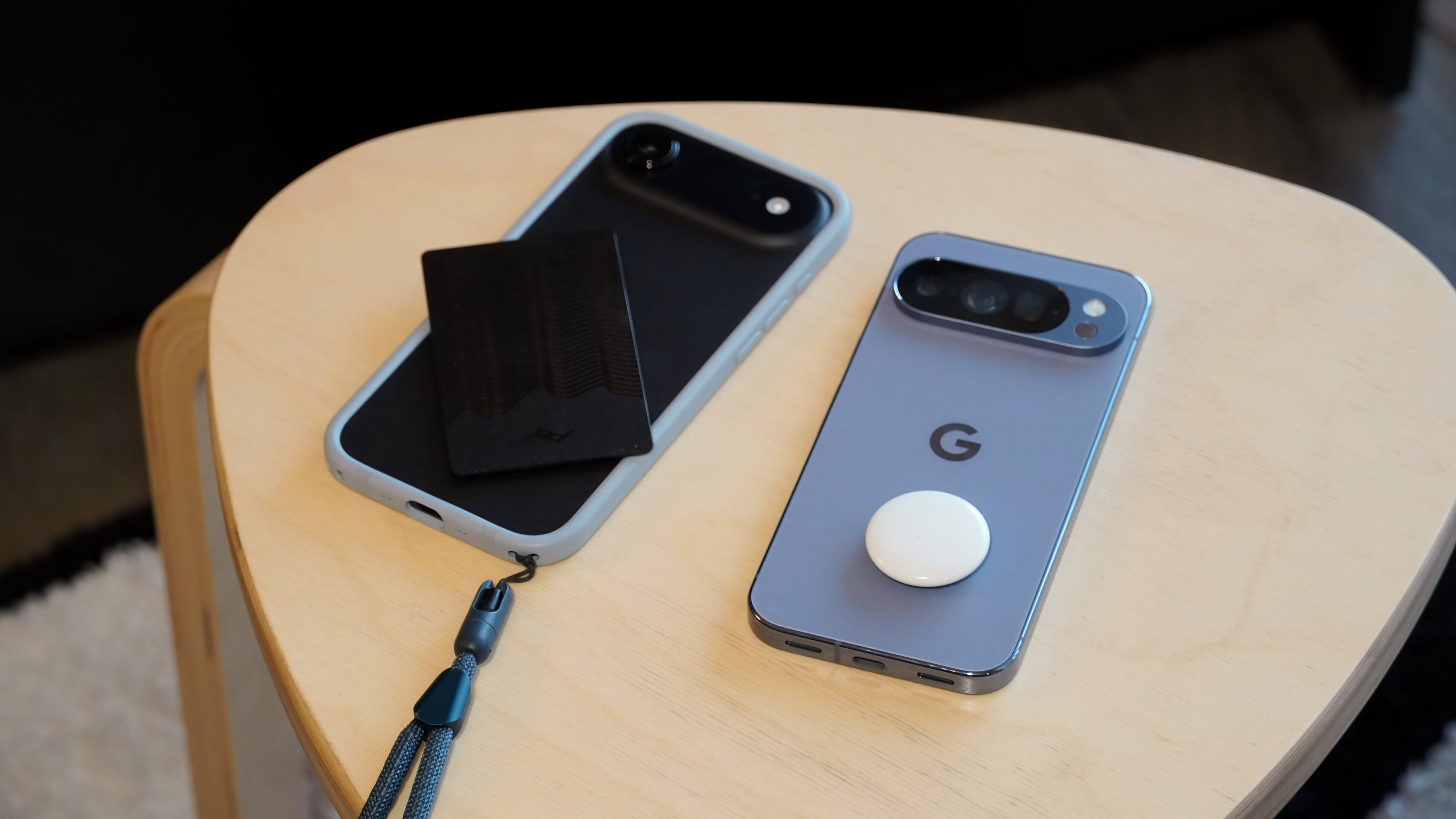 Find Hub Find My 1 Bluetooth trackers atop an iPhone and Pixel phone.