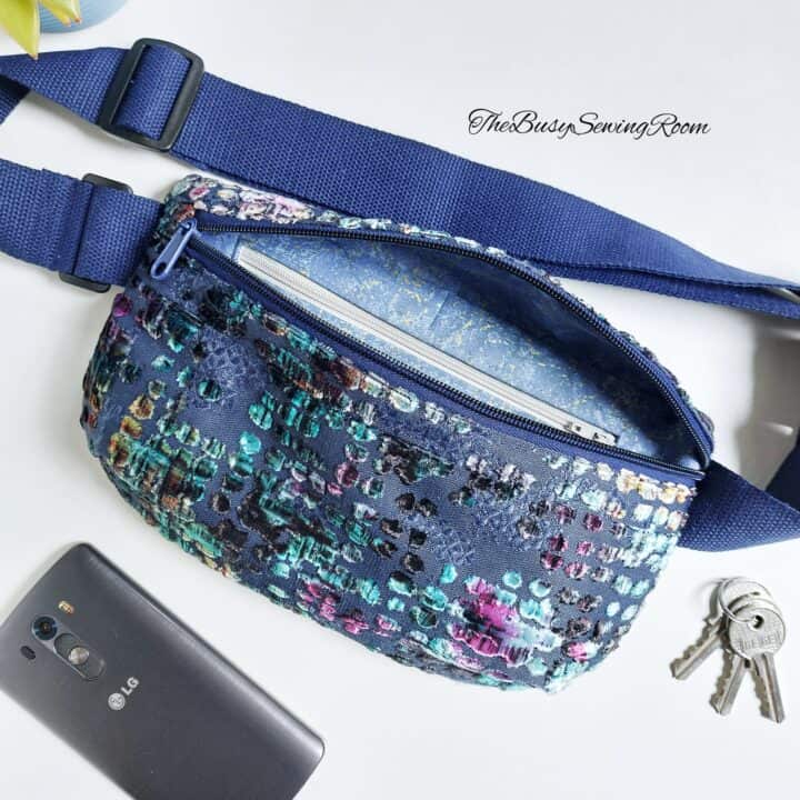 a finished fanny pack made with blue shiny upholstery fabric and a side-release buckle