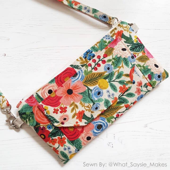 a beautiful handamade wallet bag in floral riflepaperco prints with a flap and a crossbody strap