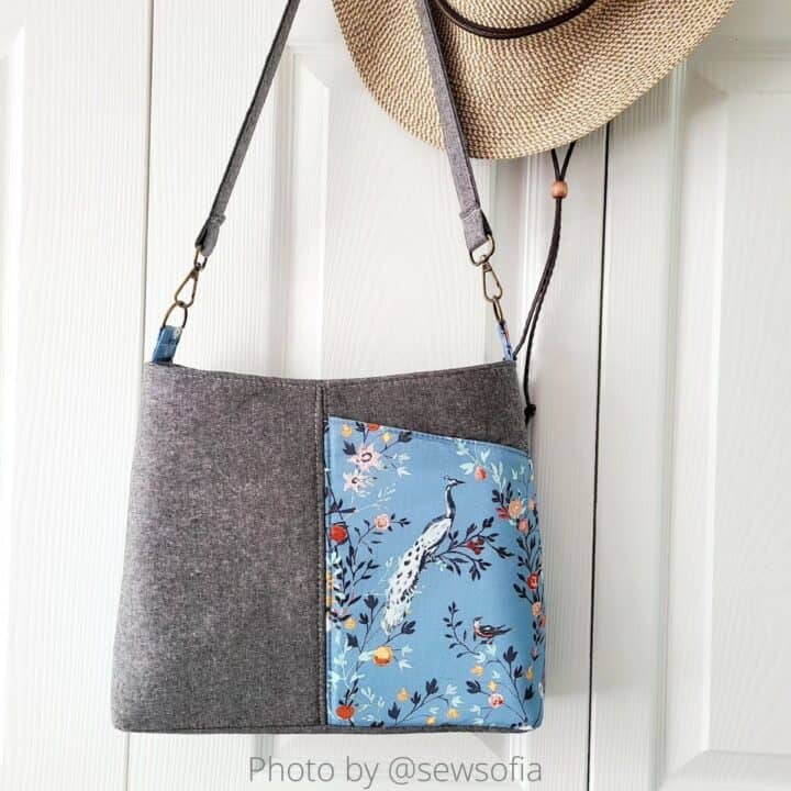 a finished handmade classic shoulder bag with a front pocket in light blue Katarina Rocella cotton print and grey Essex Linen base