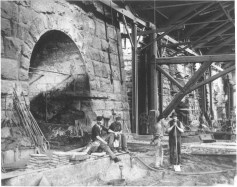 STT-L-AMERICA250PHOTO-CAPST-0614-01 This photo from the late 1860s or early 1870s shows Lackawanna Iron and Coal workers at furnace No. 5 at the Scranton Iron Furnaces. From Dan Perry’s Scranton’s Historic Furnaces: The inception of the anthracite iron industry, a landmark in American ironmaking history, reflected a shift from the predominantly rural industry to one that was to become increasingly urbanized as the size of the individual plants and the need for workers expanded dramatically. This was true, not only for Lackawanna, but throughout the Lehigh Valley, and at Danville. Anthracite ironworks served as the corporate model for the massive, integrated steel plants which evolved in places such as Pittsburgh and Bethlehem. (LACKAWANNA HISTORICAL SOCIETY)