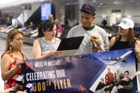 MilitaryMileslo10 Miles for Military founder Maureen Byrne reads a proclamation from Gov. Healey alongside U.S. Army Spc. Augusto Robles, his mother Eva Robles, and Military Miles Operations Coordinator Anna Stanley during the nonprofit’s celebration of its 1,000th sponsored flight. (Libby O’Neill/Boston Herald)