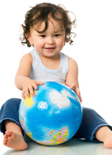 Natural Life books, with seated child handling a globe