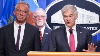 Dr. Oz speaking at a press conference table with RFK Jr next to him.
