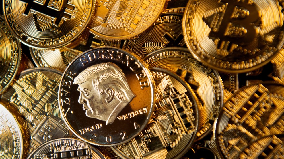 A pile of gold Bitcoins with a golden Trump "never surrender" coin sitting on top