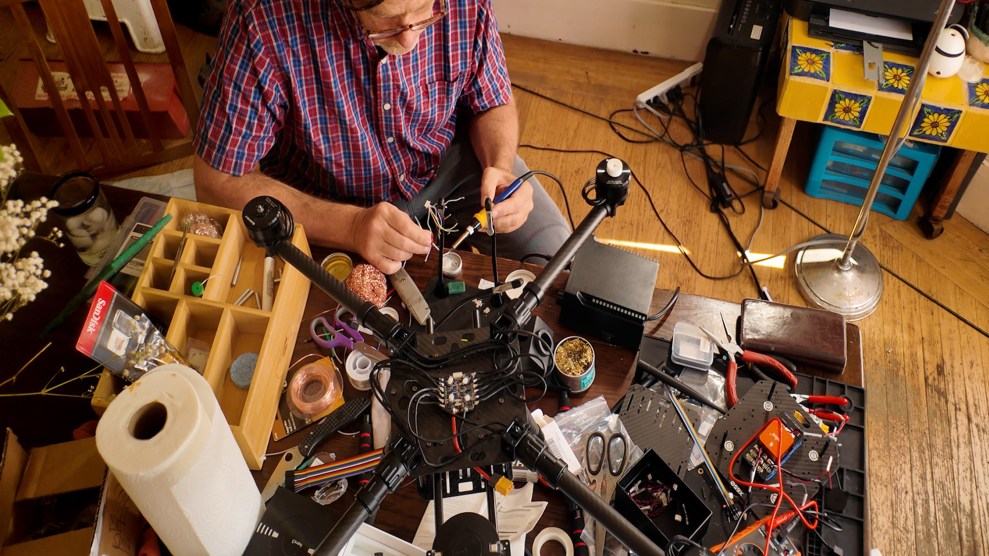 Reporter Matt Smith solders drone parts on his dining room table.