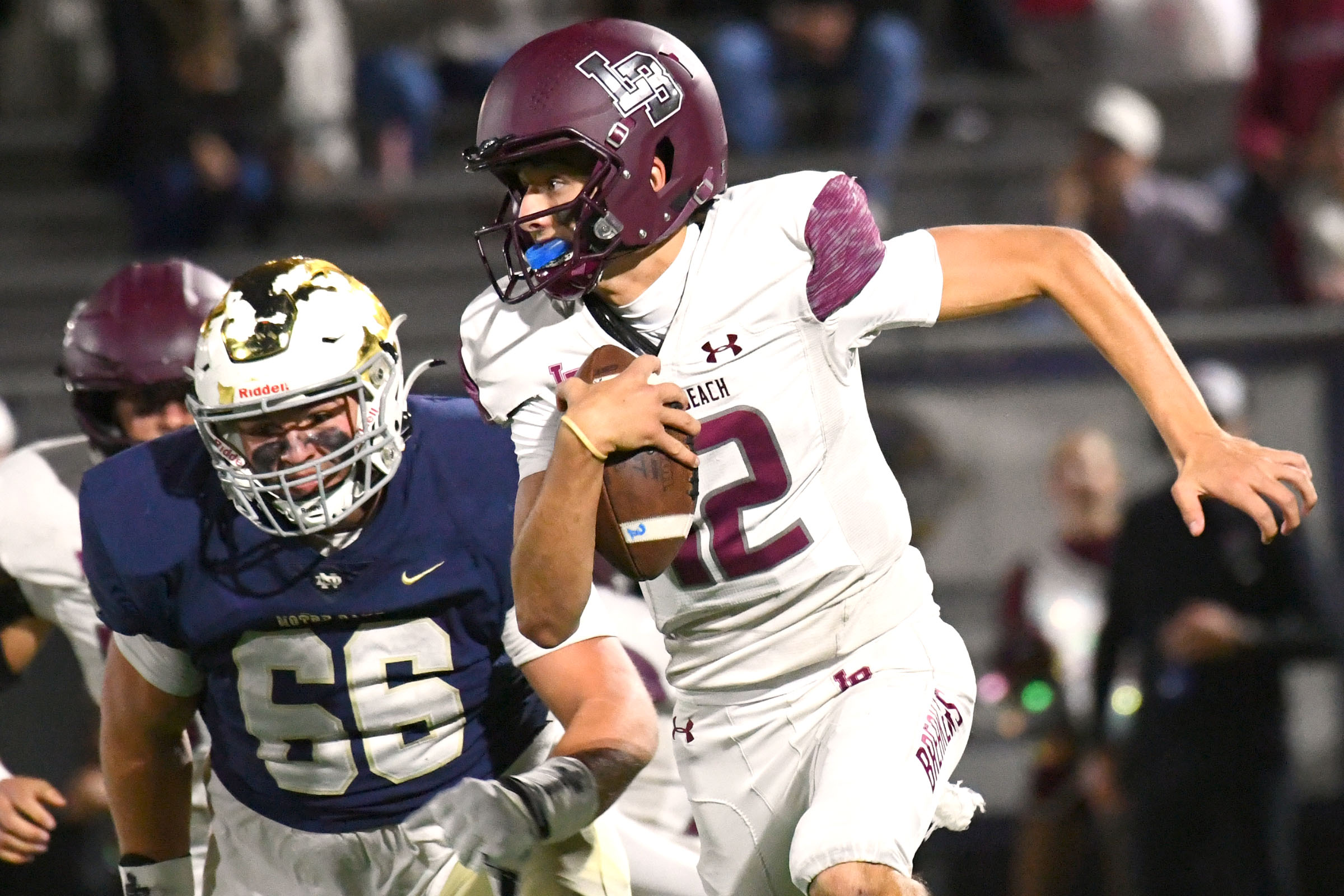 LDN-L-PREP-ND-1108-AH14 Laguna Beach quarterback Jack Hurst (12) tries to avoid being sacked by Notre Dame in a CIF-SS Div. 3 Round 1 playoff game at Notre Dame High School in Sherman Oaks on Friday, Nov. 7, 2025.(Photo by Andy Holzman, Contributing Photographer)