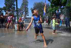 OCR-L-SASPLASH-071903 A boy runs through a water spout as he tries out the new Splash Pad at Portola Park in Santa Ana on Saturday, July 18, 2026. (Photo by Paul Rodriguez, Contributing Photographer)