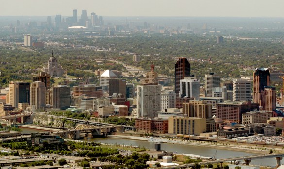 rdm aerials Downtown St. Paul is pictured in the foreground, while the Minneapolis skyline is visible in the background.