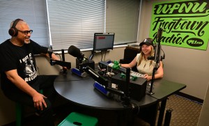 STP-L-WFNU-0731 Two people wearing headsets talk on a radio show