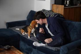 Gene-Edited_Hypoallergenic_Dogs_72167-1 Matt Walker sits at home with Bailey, his gene-edited hypoallergenic beagle.