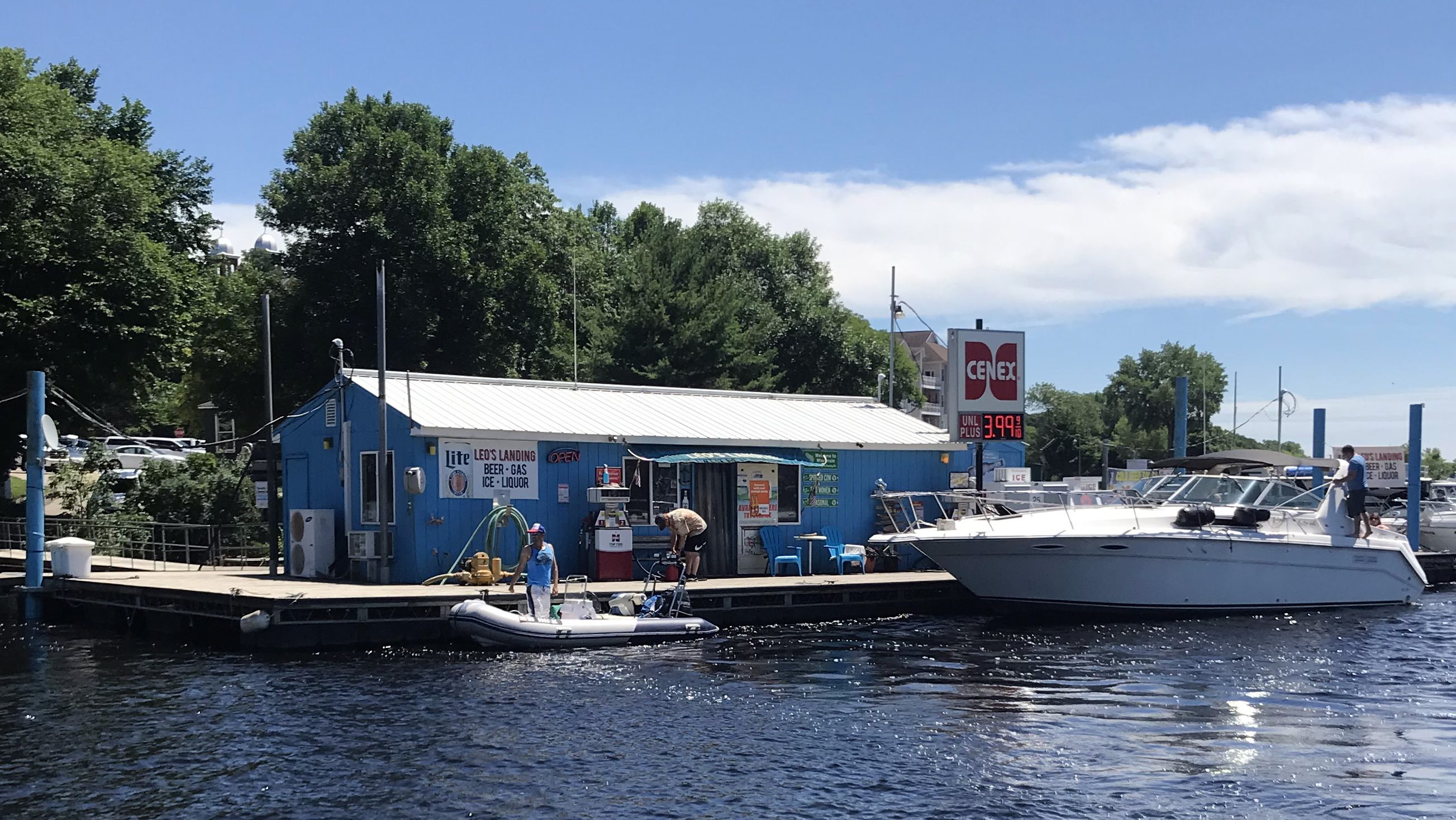 STP-L-LEOS-0827.jpg A boat parked outside a small shop on a dock.