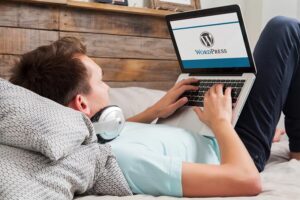 Man on laptop working on WordPress