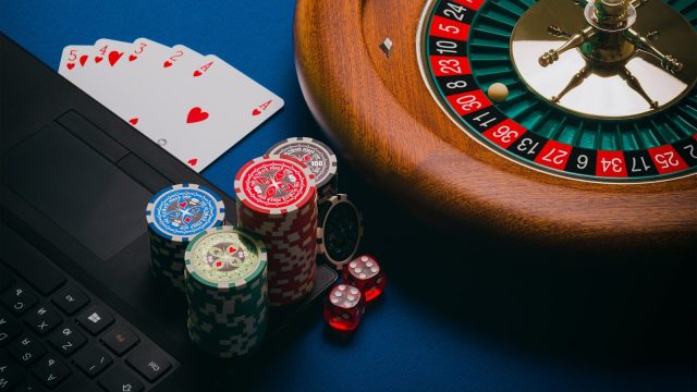Photo by Aidan Howe playing cards on brown wooden table
