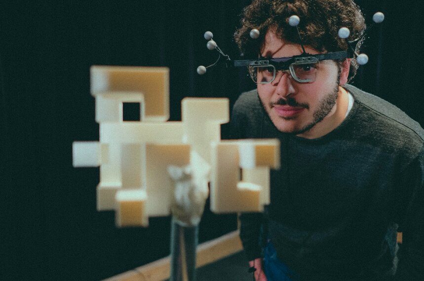 Subject conducts visual experiment with PESAO, wearing the eye-tracker, which has motion tracking installed